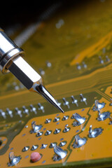 Soldering of electronic circuit board with electronic components.  Engineers repair circuit board with soldering iron.