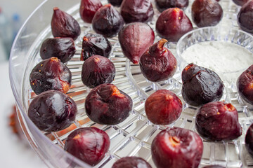 Fig. Small purple berries. On drying trays. Browned, pre-boiled for a few minutes. Drying process. The preparation of wholesome snacks.