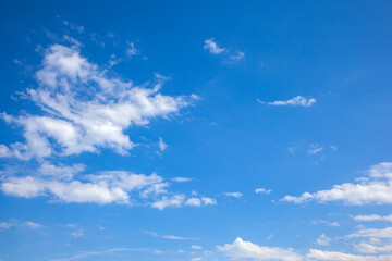 Naklejka na ściany i meble White Cirrus clouds against a blue sky.