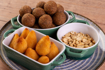 Mix of fried savory snack with coxinha, kebab and roasted and salted peanuts