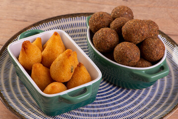 Mix of fried savory snack with coxinha, kebab and roasted and salted peanuts