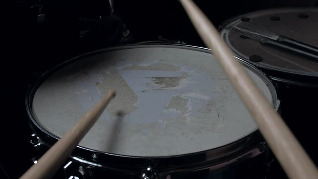 pov - the drummer plays with sticks on a snare drum, home lesson paradiddle training