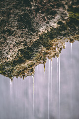 Water flowing into the river. Water flowing from the wall. water flowing from the cave wall. 
Water dripping from nature. Drops of water from wall. 