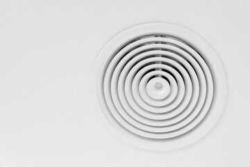 Fototapeta na wymiar Round ventilation diffuser mounted in white ceiling