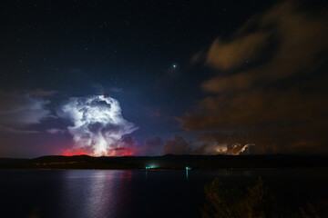 Obraz premium An ominous storm clouds are highlighted by lightning.