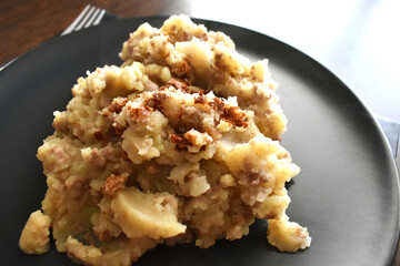 Stovies - Traditional Scottish Dish on a black plate.