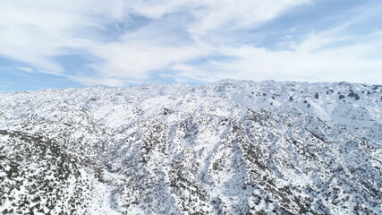 Aerial shot of mountains covered by snow. Winter season. Snow storm