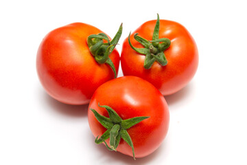 Bright red ripe tomatoes with ponytails isolated on white background