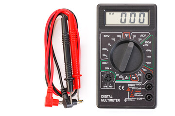 Digital electrical tester multimeter in black case isolated on white background. Digital multimeters have a numeric display, can measure voltage, current and resistance. Close-up. - obrazy, fototapety, plakaty
