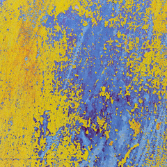 view of a patch of rusty iron with stains of old cracked yellow paint