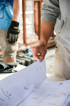 Two workers inspecting plans on a building site