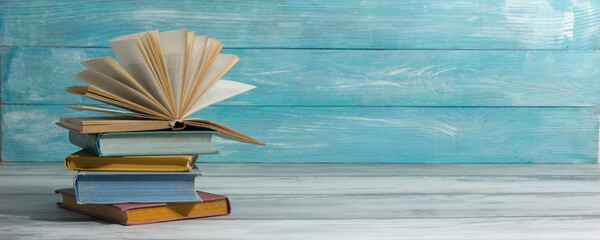 Open book, hardback books on wooden table. Back to school. Copy space