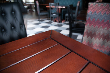 .corner of wooden table with background of pub or bar, cafe. empty white space for insertion