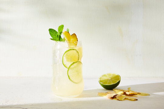 Summer drink with lime and ginger served on table