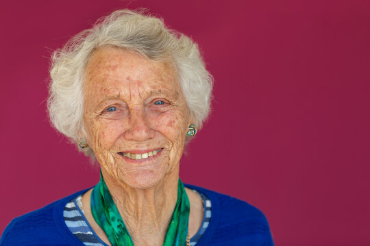 head and shoulders of vivacious octogenarian smiling and looking at camera