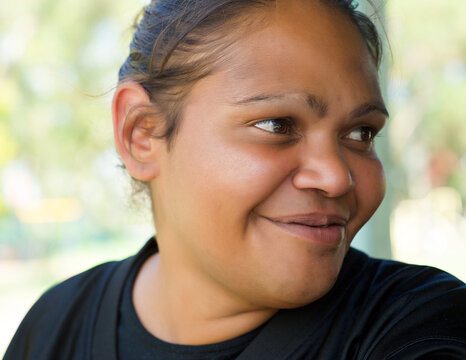 Smiling Aboriginal Woman on a Green Background