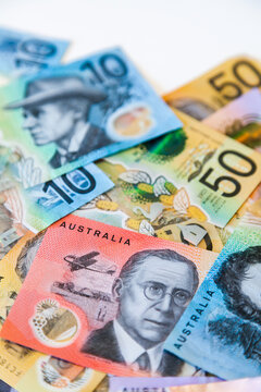 Scattered pile of australian notes in cash five dollars to fifty all new notes