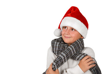 Adorable smiling blond boy is wearing Christmas or Santa's red hat and white pullover, waiting a new year beginning and gifts, isolated on white background