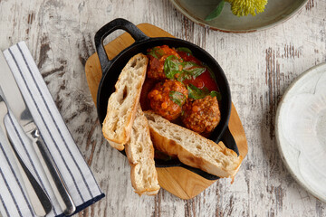 Overhead view of meatballs and bread meal on table