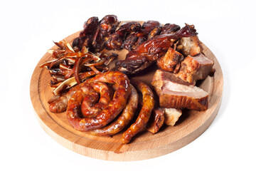 .Appetizing smoked meat, fried sausages, ribs on a wooden tray. Nicely and neatly served. cutout