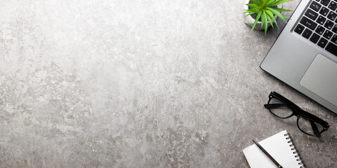 White desk office with laptop, smartphone and other work supplies with cup of coffee. Top view with...