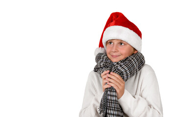 Adorable smiling blond boy is wearing Christmas or Santa's red hat and white pullover, waiting a new year beginning and gifts, isolated on white background