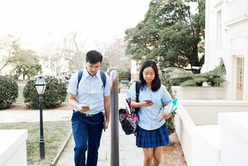 High School students walking together with phones