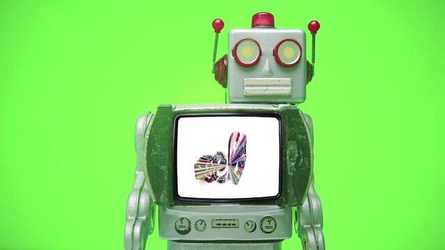 a retro robot with a hello message  with a green screen background 
