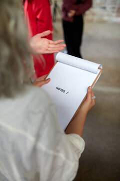 Event coordinator holding event schedule