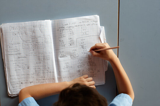 Primary school student in classroom working on homework