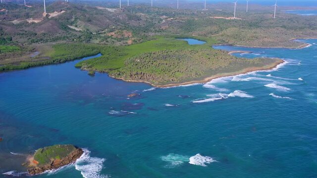 Aerial view of coast near Maimon with wind turbines in background. Dominican Republic