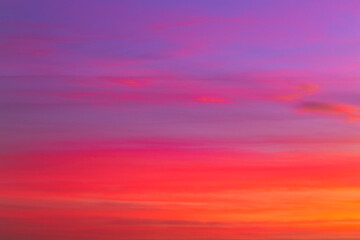 Purple and orange pastel coloured sky with clouds at sunrise