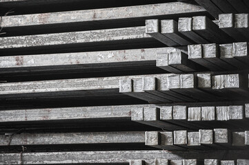 Steel billets in the warehouse of metallurgical factory. Hot ingot in a steel plant.