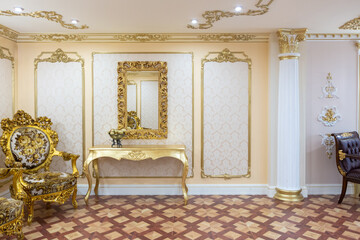 luxurious living room interior with beautiful old carved furniture of gold color with decorations...