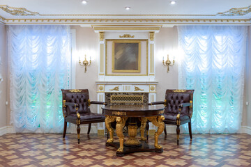 luxurious living room interior with beautiful old carved furniture of gold color with decorations on the walls in the style of the royal palace