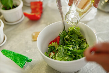 Beautiful smily handsome woman is preparing tasty fresh dishes at her kitchen at home