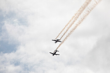 Fighter jets in the sky in airshow against clouds and sky precision flying machines against the sky clouds riding together team work collaboration close 