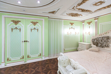 small luxury bedroom with bath and expensive furniture in a chic old baroque style.