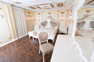 small luxury bedroom with bath and expensive furniture in a chic old baroque style.