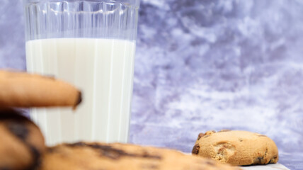 American gluten free chocolate chip cookies with glass glass of vegetable milk on gray background. Chocolate chip cookies. Sweet pastries, dessert. Culinary background. Copy space