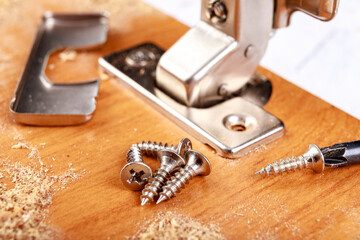 Installation of metal hinges with a soft close in a chipboard. Minor carpentry work when assembling...