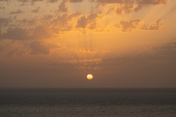 Beautiful sunset with light rays over sea
