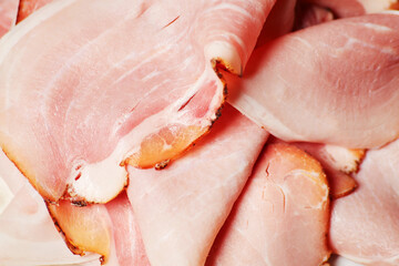 Thin sliced and served cured prosciutto beacon ham background texture
