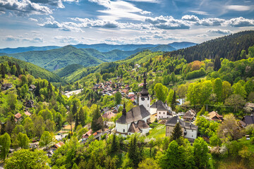 Church in The Spania Dolina village with surrounding landscape, Slovakia, Europe. - obrazy, fototapety, plakaty