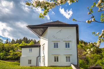 Historic building with sundial in The Spania Dolina village, Slovakia, Europe.