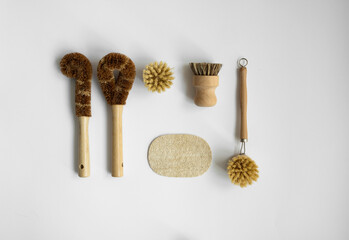 Fototapeta na wymiar Set of brushes for eco-cleaning the home, washing dishes and surfaces without chemicals on a gray surface. Zero waste kitchen cleaning concept. Eco friendly natural cleaning bamboo dish brushes.