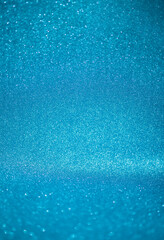 blue glitter texture christmas abstract background with bokeh