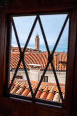 A glimpse of the Veneitan rooftops through a window of Palazzo Contarini del Bovolo