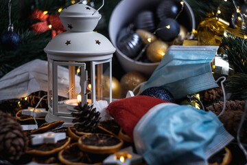 New year's still life. Christmas decorations on the table. Christmas toy. Medical mask.