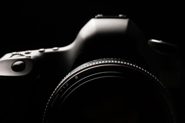 Professional modern DSLR camera low key image